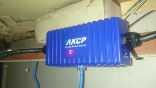 AKCP In-Line Power Meter installed under the floor below the ATM.