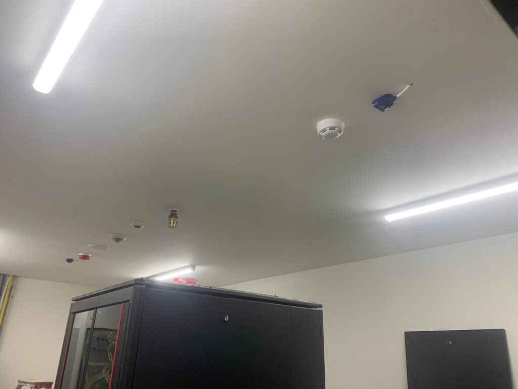 Dual temperature and humidity sensor installed on ceiling of server room