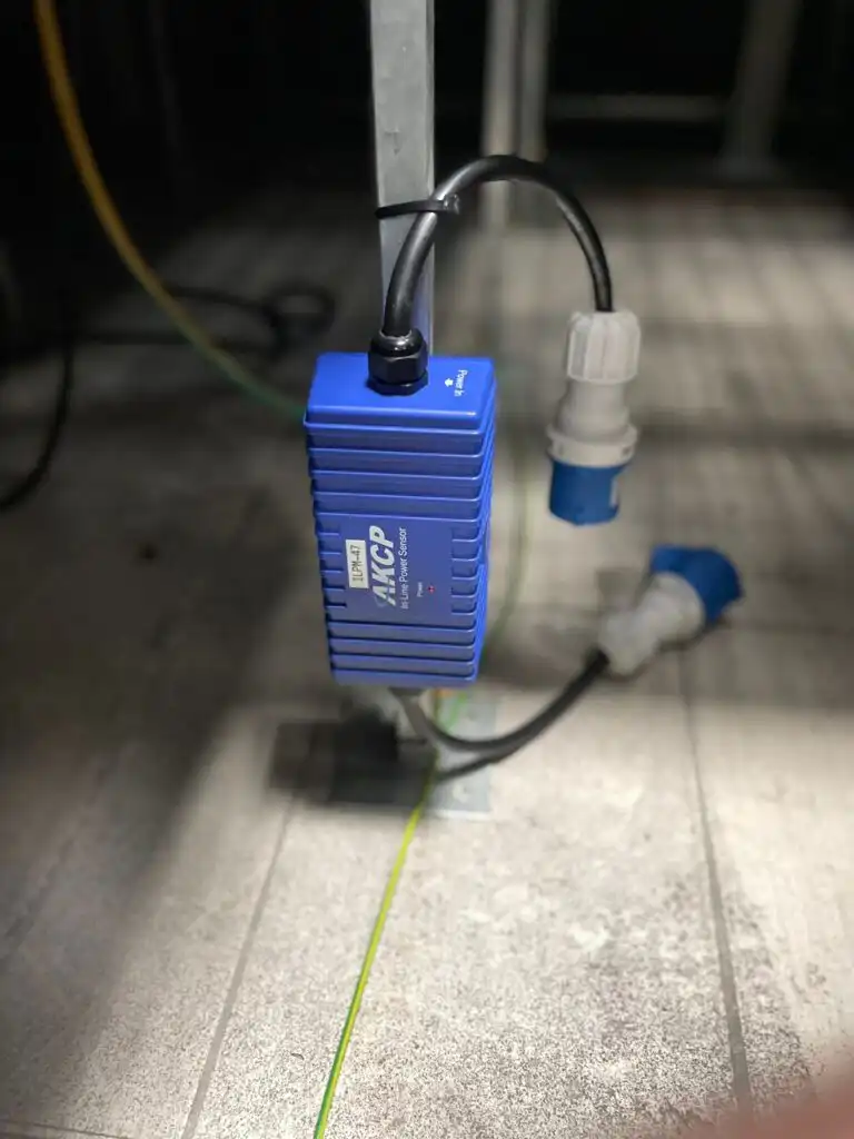 In line Power Meters under raised access flooring provide monitoring for each racks power consumption